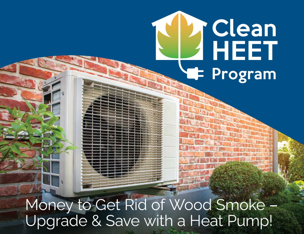 Heat pump against an external home wall and Clean HEET Program logo, with text: Money to Get Rid of Wood Smoke – Upgrade & Save with a Heat Pump!